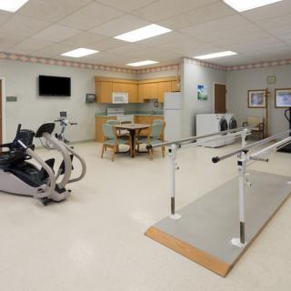 A physical therapy room equipped with rehabilitation and exercise machines.
