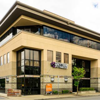 Exterior view of a modern fitness center in an urban area.