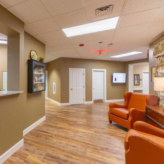 A modern office reception and waiting area with comfortable seating and stylish interior design.