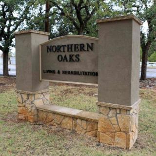 A sign for Northern Oaks Nursing & Rehabilitation, set in an outdoor landscape.