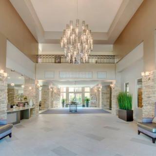 A luxurious and spacious lobby featuring a stunning chandelier.
