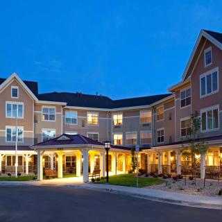 A well-lit hotel exterior during the night.