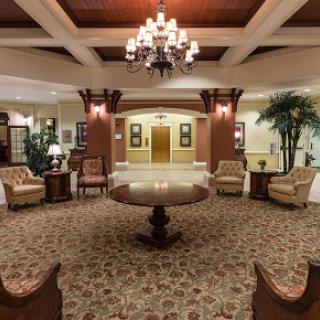 A beautifully designed lobby featuring elegant furniture and a stunning chandelier.