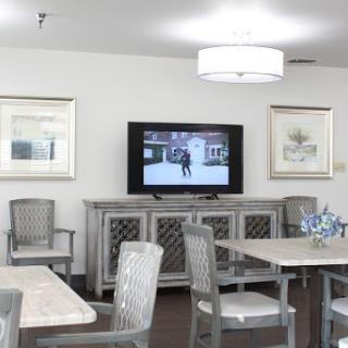 A modern lounge area featuring stylish furniture and a television, designed for relaxation and communal activities.