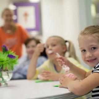 Children enjoying ice cream together at a table.
