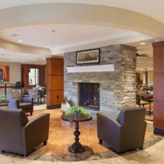 A modern lobby with comfortable seating and a cozy fireplace.