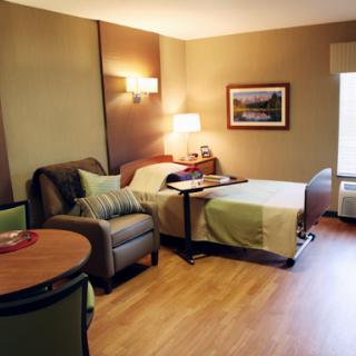 Cozy and inviting hotel room featuring a comfortable bed, living area, and natural light.
