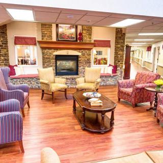 A cozy living room with comfortable armchairs and a fireplace.