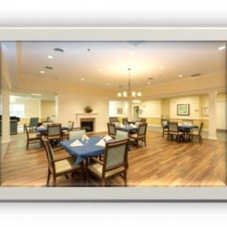 A well-lit dining area with multiple tables and chairs arranged neatly.