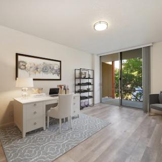 A bright and modern home office featuring a stylish desk, ergonomic chair, and ample natural light.