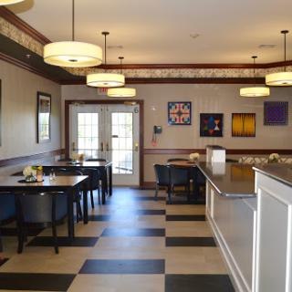 A modern dining area with stylish lighting and art on the walls.