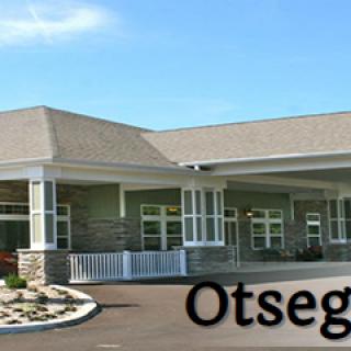 A modern building with a large entrance and well-maintained surroundings.