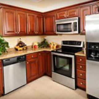 A modern kitchen with wooden cabinets and stainless steel appliances.