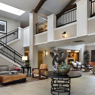 A modern lobby with stylish furniture and a decorative sculpture centerpiece.