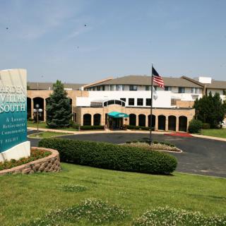 A retirement community with a manicured lawn and a flag in front.