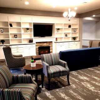 A cozy living room with comfortable seating and a fireplace.