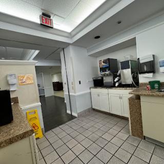 A view of a clean office kitchen space equipped with appliances.