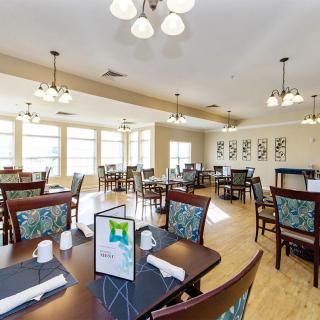 An elegantly decorated dining area with neatly arranged tables and chairs.