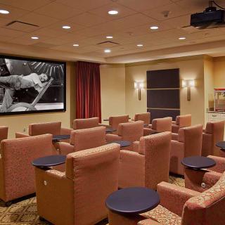 A cozy home theater setup with comfortable seating and a large screen.