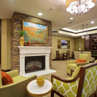 A modern living room with a cozy fireplace and stylish furniture.