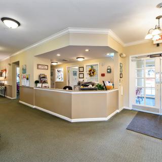 A welcoming reception area with a central desk and bright lighting.