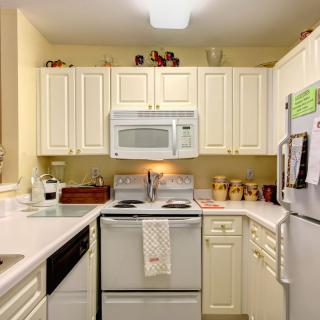 A cozy kitchen with white cabinets and modern appliances.