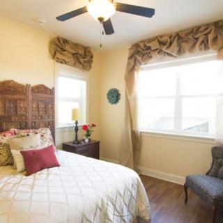 A cozy bedroom with elegant decor and natural lighting.