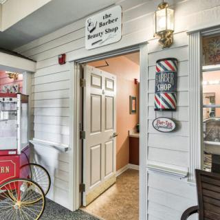 Entrance to a charming barber and beauty shop with vintage decor.