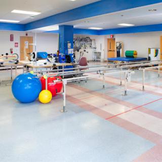 A well-equipped physical therapy room featuring various rehabilitation tools and exercise equipment.