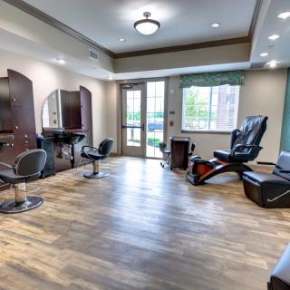 A modern salon interior with styling chairs, mirrors, and spa equipment.
