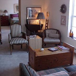 A cozy living room featuring a mix of seating options and warm lighting.