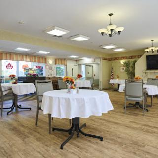 A cozy dining area featuring neatly arranged tables and a warm, inviting atmosphere.