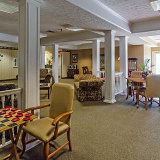 A cozy indoor seating area with a game table set up for checkers.