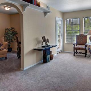A cozy living room with comfortable seating, natural light, and tasteful decor.