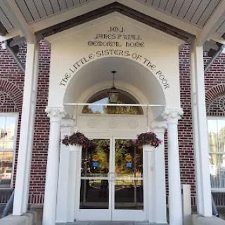 Entrance to a library with brick architecture and floral decorations.