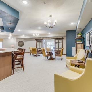 A spacious modern living room with comfortable seating and a bar area.