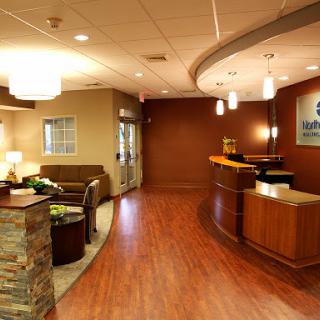 A welcoming and modern reception area featuring stylish furniture and warm lighting.