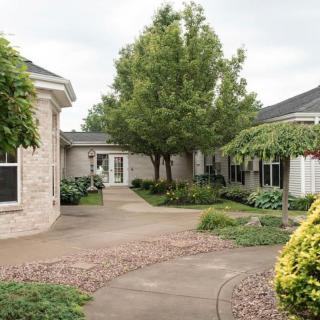A serene courtyard with lush greenery and a winding pathway.