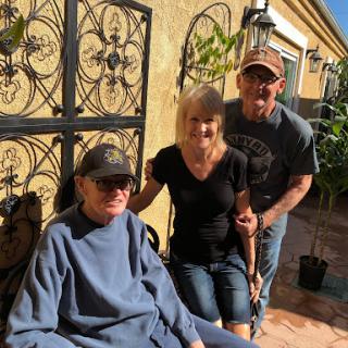 A warm moment shared among family members outside on a sunny day.