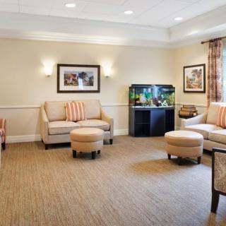 A cozy living room with comfortable seating and a vibrant aquarium.