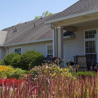 A cozy home with a well-maintained garden and a covered porch.