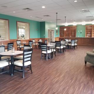 Spacious dining area with neatly arranged tables and chairs, featuring a stylish interior design.
