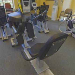 A gym room equipped with various exercise machines.