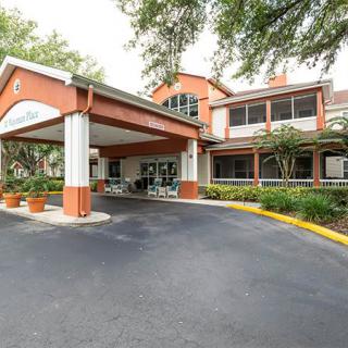 Entrance to a building with surrounding trees and landscaping.