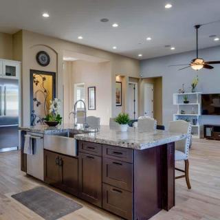 A modern open-concept kitchen with an island and sleek furnishings.