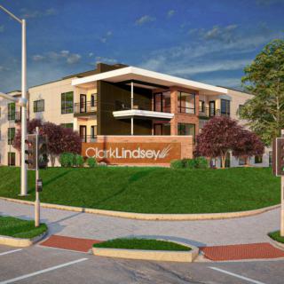 A modern residential building with a well-maintained landscape and clear signage.