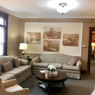 A cozy living room with comfortable sofas and wall art.