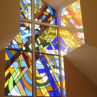 A beautiful stained glass window casting vibrant colors in the light.