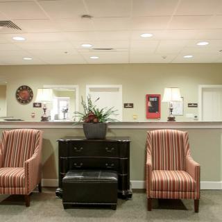 A well-furnished lobby with comfortable seating and a reception area.