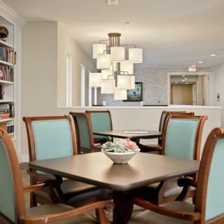 A modern dining area with elegant furniture and contemporary lighting.
